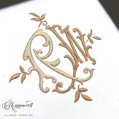 an embroidered monogram on the side of a piece of paper