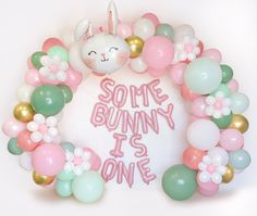 some bunny is one balloon wreath on a white wall