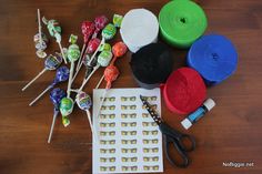 candy, lollipops, scissors and other items on a wooden table top