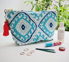 "Ojitos canvas pouch Keep your day to day items in this handy clutch. Carry your phone & wallet with you and relax by the pool or use it as a toiletry bag that'll look pretty cute in your bath. It has the perfect size for keeping it in your tote or suitcase. Its mosaic patterns print goes well with summer dresses and ice-cream eating. Or so we think! ▶ measures: 10\" x 7.1\" (25.5 cm x 18 cm) ▶ wood tag & tassel keychain ▶ blue ikat canvas Keep your stuff in pretty pouches: https://www.e Bohemian Pouch Cosmetic Bag For Travel, Bohemian Rectangular Travel Cosmetic Bag, Bohemian Cosmetic Pouch For Travel, Bohemian Cosmetic Bag For Travel, Floor Mosaic, Keychain Blue, Travel Toiletry Bag, Wood Tags, Resort Fashion