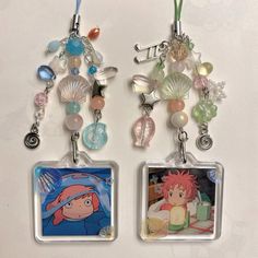 two key chains with charms attached to them on a white surface, one has an image of naruto and the other has seashells