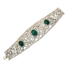 Diamond and Emerald Bracelet in 18k White Gold Features Three Cabochon Emeralds weighing a total of 20.00 carats estimated set with Round Brilliant Diamonds in Heart and Paisley design 30.00 carats in total of Diamonds Total Stone weight is 50.00 carats estimated Bracelet measures 7 inches long and 1.60 inches wide and weighs 101.4 grams Marked Chaar, 750 BUY WITH CONFIDENCE Authenticity is guaranteed for every item we sell. Luxury Diamond Jewelry With Cabochon Cut, Luxury Cabochon Diamond Jewelry, Luxury Cabochon Bangle Jewelry, Formal Diamond Cabochon Jewelry, Elegant Cabochon Bangle Jewelry, Luxury Wedding Bracelet With Cabochon, Luxury Cabochon Bracelets For Wedding, Luxury Silver Bracelets With Cabochon, Elegant Cabochon Bracelets For Anniversary