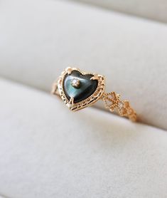 Carter Black Mother of Pearl Heart Ring features a gorgeous black heart carved our of genuine mother of pearl, architecturally inspired by Victorian era jewelry. Set in a 18K Gold Vermeil golden lace filigree band and adorned with crystals, Perfect for a surprise gift for yourself and loved ones. The ring also has a matching necklace in our shop! ◊ This is a made to order ring and will take 3 weeks to make. Don't worry, we will keep you in the loop when it is ready to ship!  ◊ Available in US Ri Elegant Carved Jewelry For Promise Ring, Elegant Black Heart Ring For Weddings, Elegant Engraved Heart Ring As Gift, Elegant Engraved Heart-shaped Ring, Elegant Black Mother Of Pearl Jewelry, Victorian Era Jewelry, Golden Lace, Gold Heart Ring, Gold Elephant