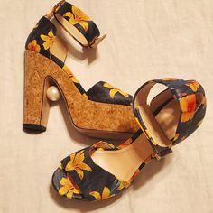 He's Have Never Been Worn Outside Just A Tiny Bit Of Wear And Tear On The Bottom From Being Tried On Around The Apartment. But Other Than That They Are Brand New. They Are Cork Platform And Heal With A Leather Upper That Has Blue And Black Background And Yellow Orange And Green Highlights In The Floral Design. Ankle Strap Is Held Together By Gold Metal Buttons And The Strap Is Finished Off With Gold Medal. These Are Beautiful And Have A Pearl Detail In Between The Heel. The Bottom Says Size 40 B Multicolor Platform Slip-on Heels, Green Highlights, Nicholas Kirkwood, Metal Buttons, Platform Sandals, Black Backgrounds, Ankle Strap, Gold Metal, Leather Upper