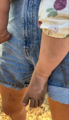 a close up of a person's legs and leg with dirt on the ground