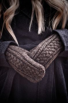 a close up of a person wearing mittens