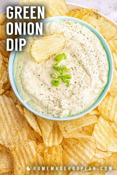 green onion dip in a blue bowl surrounded by chips on a white plate with text overlay