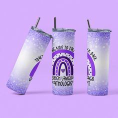 two tumblers with purple and white designs on them, one has a rainbow in the middle