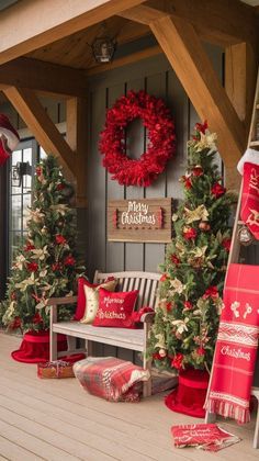 a porch decorated for christmas with red and white decorations