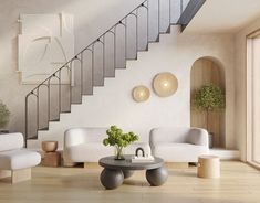 a living room with white furniture and stairs