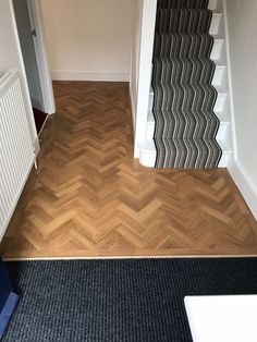 an empty hallway with wood flooring next to a radiator