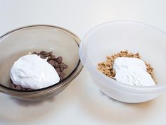 two bowls filled with food sitting on top of a white table next to each other