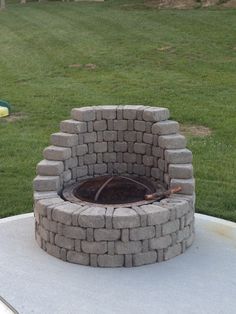 an outdoor fire pit made out of bricks