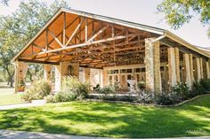 a large wooden building sitting on top of a lush green field