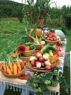 a table filled with lots of different types of fruits and veggies on it