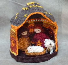 a crocheted nativity scene is displayed on a table