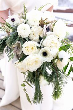 a bouquet of white flowers sitting on top of a table