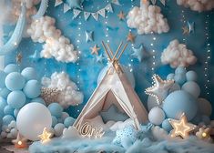 a blue and white backdrop with stars, clouds and a teepee tent