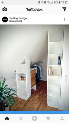 an instagram photo of a white bookcase in the corner of a room next to a plant