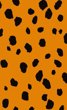 an orange background with black spots in the shape of hearts on it's sides