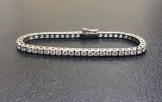 DeKara Designs Collection Metal- 90% Platinum, 10% Iridium, 23.8 Grams. Stones- 51 Round Diamonds F-G Color VVS-VS1 Clarity 5.00 Carats Measurements- 7 Inches Long. This bracelet is truly a masterpiece! An entirely handmade/hand assembled Art Deco Influenced 90% Platinum diamond tennis bracelet. This beautiful bracelet features 50 fiery near colorless high clarity round diamonds. All the diamonds are professionally set between four prongs. The settings are all separately made and hand assembled Hallmarked White Gold Diamond Bracelet, Luxury Hallmarked Sterling Silver Bracelet, Formal Hallmarked Sterling Silver Bracelet, Classic Diamond Bracelet With Hallmark, Classic Hand Set Sterling Silver Bracelet For Formal Occasions, Formal Fine Jewelry Hallmarked Tennis Bracelet, Classic Hallmarked White Gold Tennis Bracelet, Formal Sterling Silver Bracelet With Prong Setting, Formal Diamond White Sterling Silver Bracelet