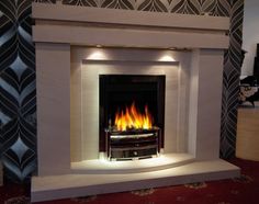 a fire place in the middle of a living room with red carpet and wallpaper