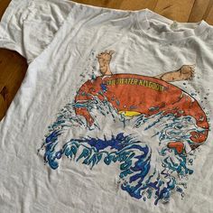 This piece is a vintage souvenir t-shirt from the 1990s for the water park, Wild Water Kingdom, in Brampton, Ontario, Canada; now known as Wet'n'Wild Toronto. The front of this shirt has a funny graphic of someone's feet visible over an inner tube floaty that is splashing through water. The shirt itself is made from 100% cotton with a single stitch construction. This piece is in good vintage condition with regular wear and fading from age. There are no major stains, yellowing or flaws. Please al