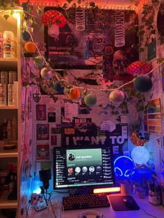 a desktop computer sitting on top of a desk under a neon light filled ceiling above it