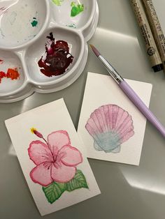 two watercolors, one with a flower and the other with a painting brush