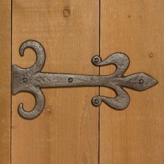 an old metal hook on a wooden door