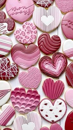 many heart shaped cookies are arranged together