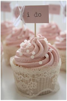 cupcakes with pink frosting and white polka dots are on top of each other