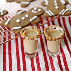 two glasses filled with ice cream sitting on top of a red and white table cloth