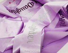 purple satin ribbons with the word gummy written on one side and two different types of writing on the other