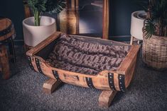 a wooden trunk sitting on top of a carpeted floor next to a potted plant