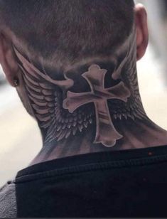 the back of a man's head with a cross and wings tattoo on it