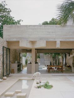 an outdoor kitchen and dining area are shown in this photo, while the patio is surrounded by stone walls