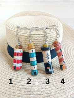 four crayons are hanging from a hat on a straw hat holder, with the numbers 1 2 3 4