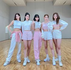 four girls in white and pink outfits posing for the camera