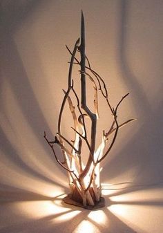 a light that is sitting on top of a tree branch in the middle of a room