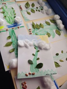 the paper is made to look like clouds and trees with green leaves on them,