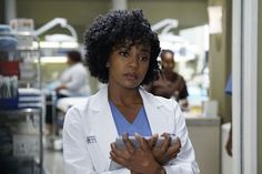 a woman in a lab coat standing with her arms crossed