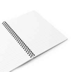 an open spiral notebook on a white background with clippings to the bottom left