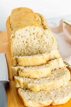 a loaf of bread sitting on top of a wooden cutting board next to a knife