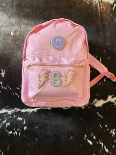 📚 Nylon backpack 📚Dimensions 28.5x37.5x13 cm 📚If you want patches attached let me know in notes placement Pink School Bag With Letter Patch, Pink School Bags With Letter Patch, School Backpack With Embroidered Patch, Standard School Backpack With Logo Patch, School Backpack With Logo Patch, Customizable Pink Backpack For Students, Clear Travel Bag, Personalized Cosmetic Bags, Pink Pouch