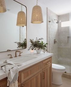 a bathroom with two lights hanging from the ceiling