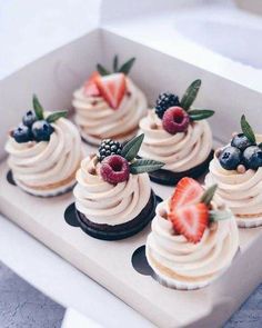 an instagram photo of some cupcakes with berries and cream frosting on them