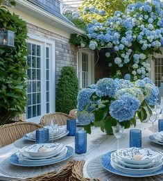 the table is set with blue and white dishes