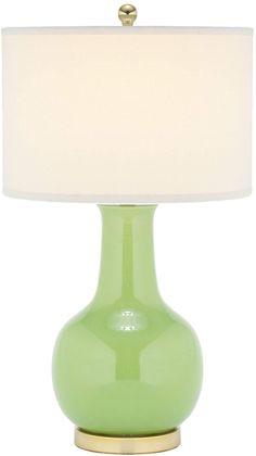 a green table lamp with a white shade