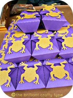 purple and gold paper with yellow frogs on it